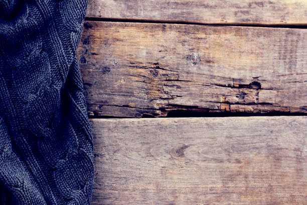 istock knitted plaid, sweater on old wooden boards 638653242