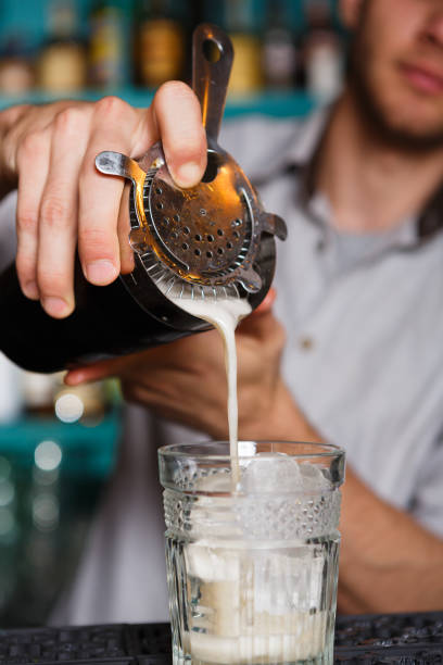 istock Young Barman's making shot cocktail, pouring syrup into glass 638653498