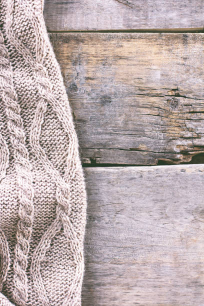istock knitted plaid, sweater on old wooden boards 638654372
