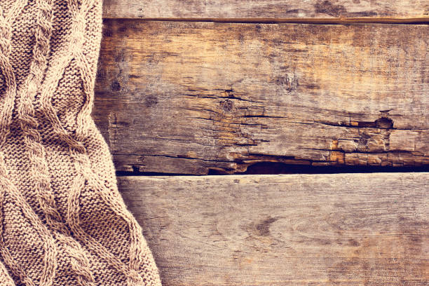 istock knitted plaid, sweater on old wooden boards 638655606