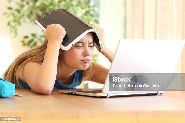 Bored Student Doing Homework Stock Photo - Download Image Now - Confusion, Teenager, Student
