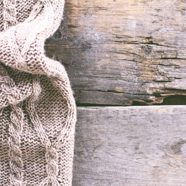 istock knitted plaid, sweater on old wooden boards 638658544