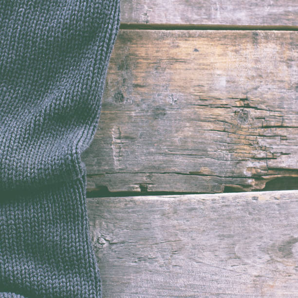 istock knitted plaid, sweater on old wooden boards 638658970