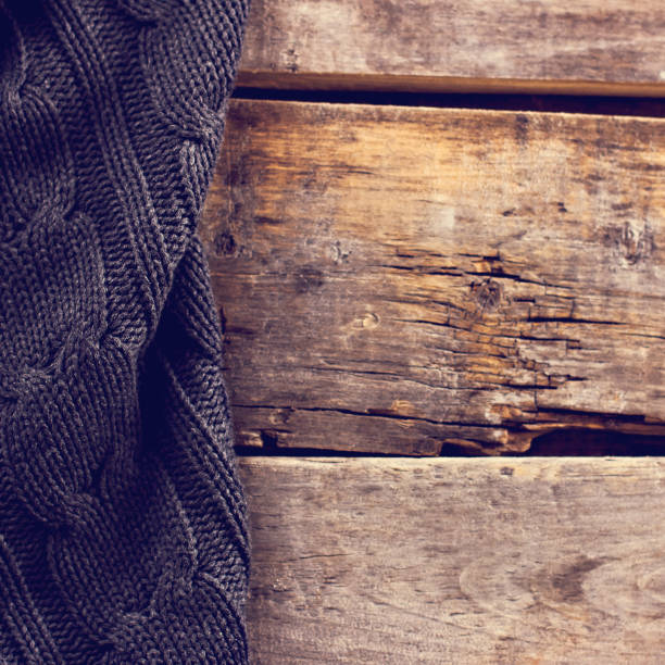 istock knitted plaid, sweater on old wooden boards 638659236
