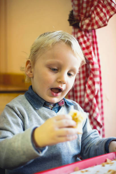 istock Blond haired boy child eating a pie 638659254
