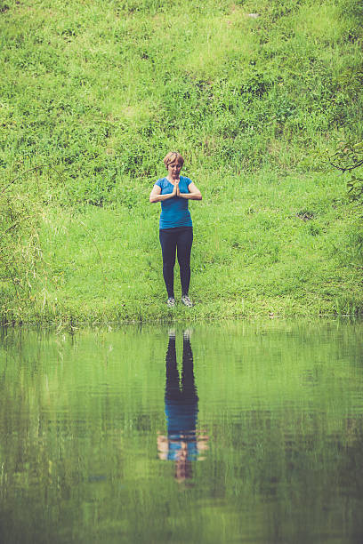 istock Mediterranean Active Seniors stretching -  Woman exercising in rainy forest 638663914