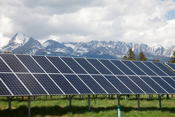 istock Solar panels with snowy mountains in the background 638664074