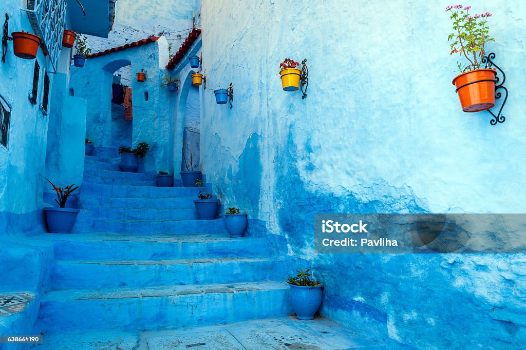 Blue staircase & colourful flowerpots, Chefchaouen,Morocco,North Africa Chefchaouen is a blue city in the north of Morocco. The place is named after the mountain tops behind the village which look like two horns of a goat (chaoua). Chefchaouen is a touristic place with many visitors from all over the world.Morocco,North Africa,Nikon D3x Morocco Stock Photo