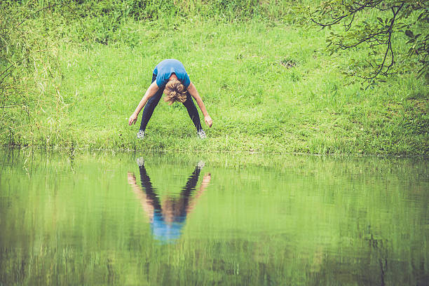 istock Mediterranean Active Seniors stretching -  Woman exercising in rainy forest 638664696