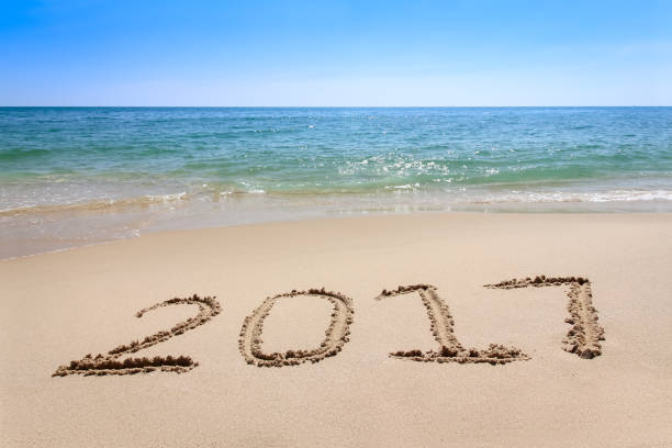istock Year 2017 written at the sand beach with sea wave 638665222