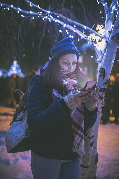 istock Beautiful young woman using her mobile phone at night. 638666488