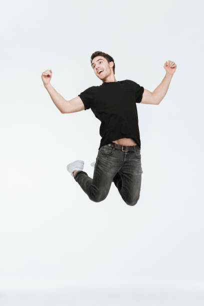 istock Happy young man jumping over white background 638666728