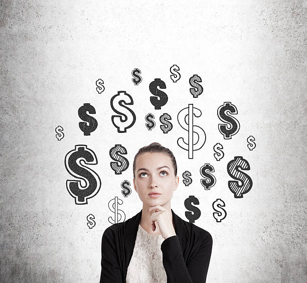 istock Girl and dollar signs on concrete wall 638667262