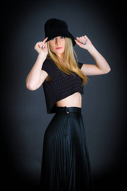 istock Young blonde model with black hat during a shooting session 638668762
