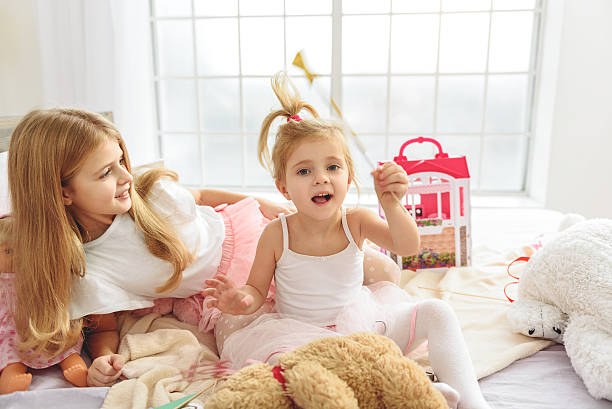 istock Happy girls playing in bedroom 638672396