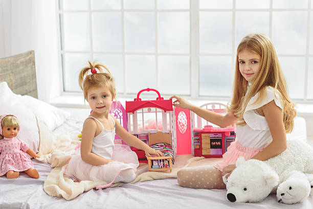 istock Pretty girls enjoying game with dolls 638672738