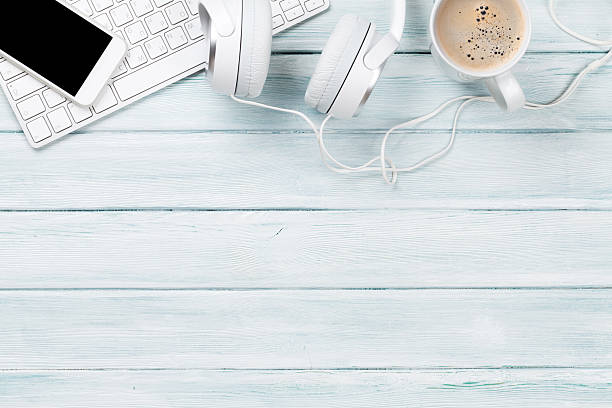 istock Headphones, phone and pc on wooden desk table 638672862