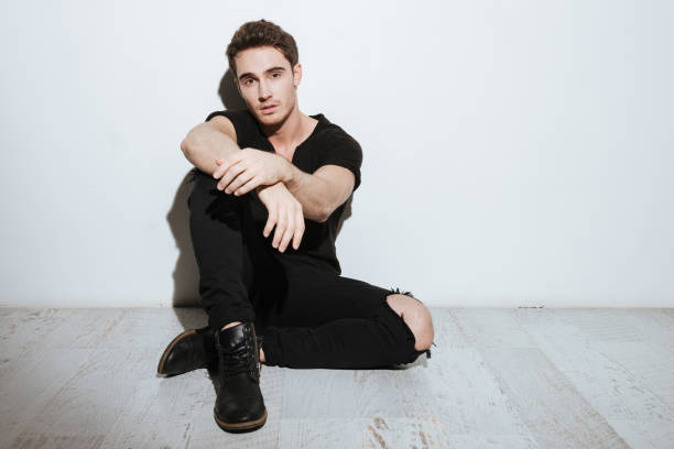 istock Young handsome man sitting over white background 638673016