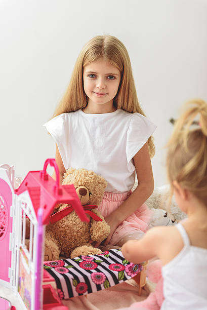 istock Pretty children entertaining with toy house 638673618
