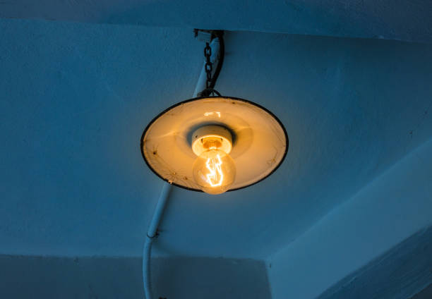 istock Lighting light bulb on the cable in dark room 638675186