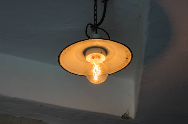 istock Lighting light bulb on the cable in dark room 638675238