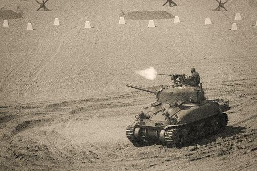 ForWorld War 2 Sherman M4 Tank Firing Weapon on Battle Field. Very similar to Utah Beach during Normandy Invasion.