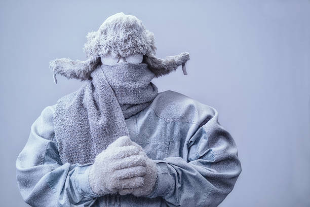 man in parka, hat and scarf frozen from the cold - luva peça de roupa imagens e fotografias de stock