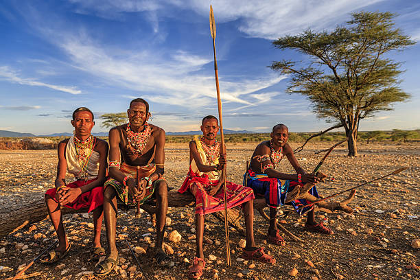 African warriors from Samburu tribe, central Kenya, East Africa African warriors from Samburu tribe resting on savanna, central Kenya. Samburu tribe is one of the biggest tribes of north-central Kenya, and they are related to the Maasai. kenyan man stock pictures, royalty-free photos & images