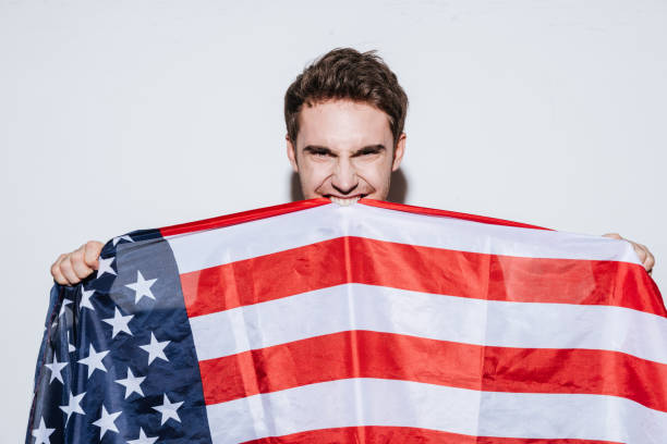 istock Emotional man posing while holding USA flag 638677518