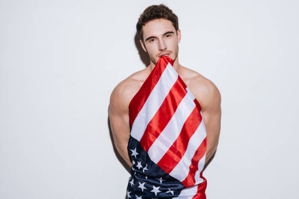 istock Handsome man posing at studio holding USA flag. 638677634