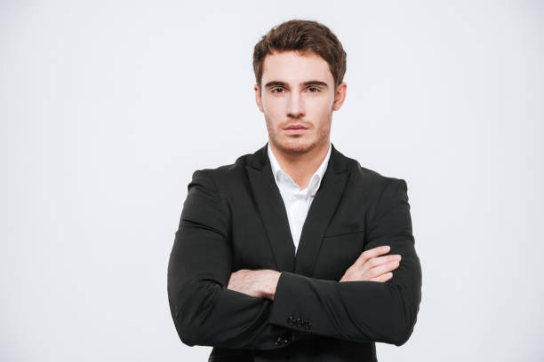 istock Confident young business man in suit standing with arms folded 638678016