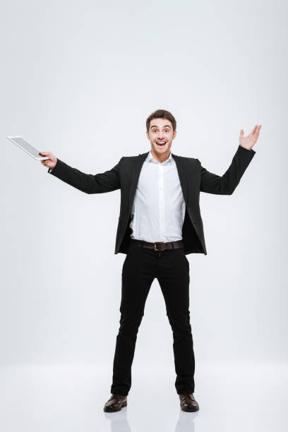 istock Happy excited businessman holding tablet computer over white background 638678232
