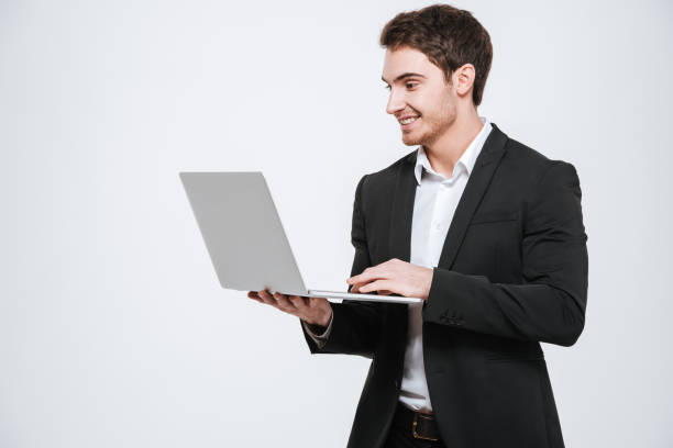 istock Handsome young caucasian businessman holding laptop 638680370