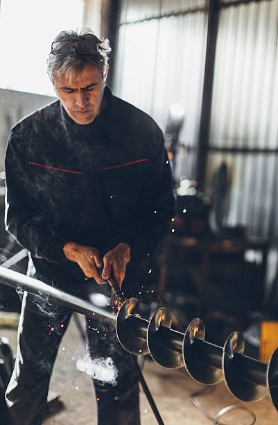 istock Senior man welding metal... 638680934