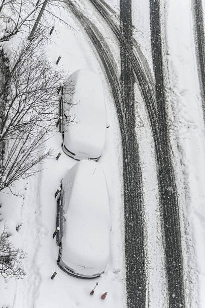 istock Cars under snow on a parking lot during winter snowfall 638682380