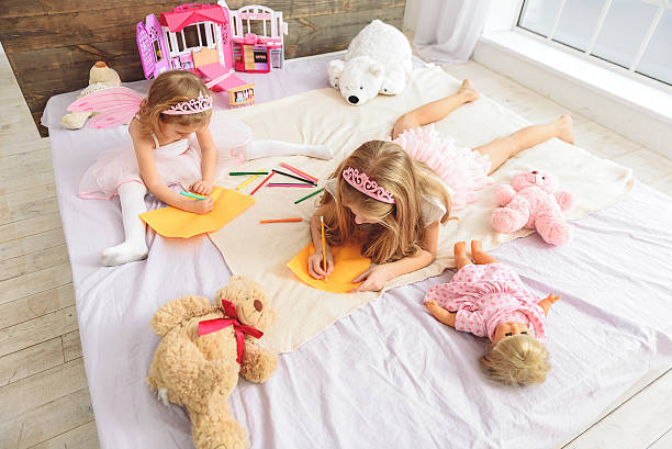 istock Cute sisters creating pictures at home 638682660