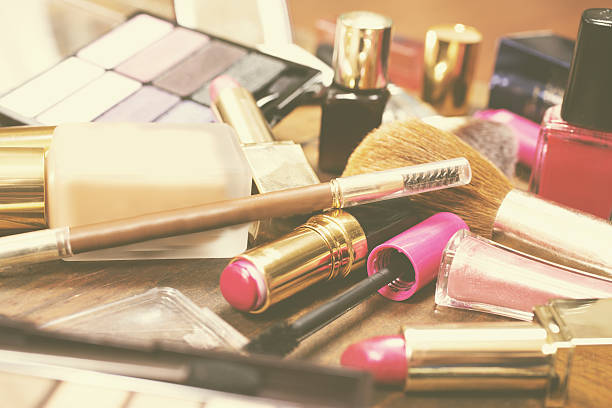 istock Pile of various cosmetics, make-up lie on wooden dressing table. 638683060