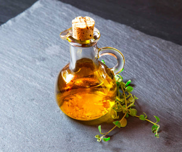 istock Olive oil bottle with oregano herb 638683130