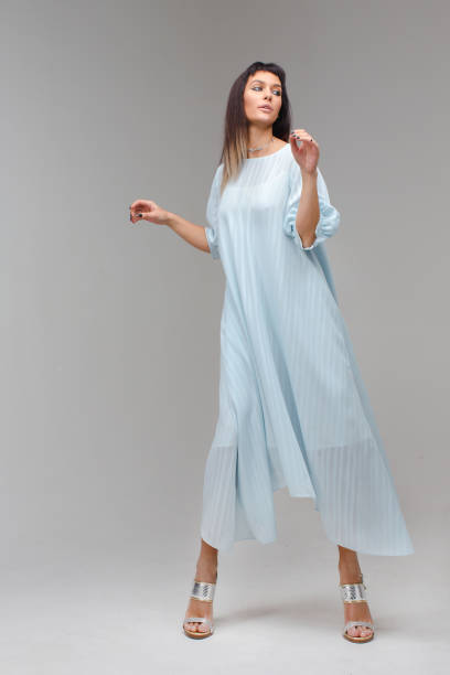 istock Woman make step in light long blue dress in studio 638685062