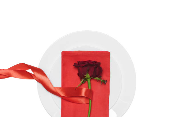 istock red rose with ribbon on plate  white background. 638686408