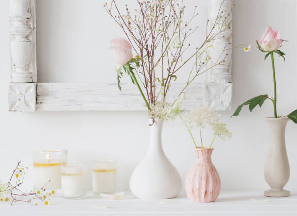 istock flowers in a vase and candles on white background 638687182
