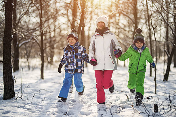 istock Happy children running in beautiful winter forest 638687422