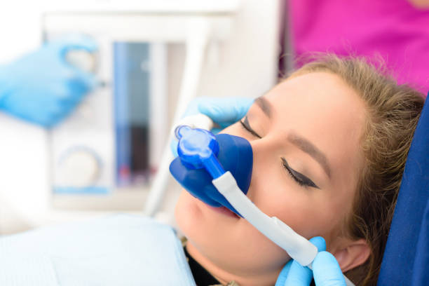 Inhalation Sedation at Clinic Beautiful getting woman inhalation sedation at dental clinic dental equipment stock pictures, royalty-free photos & images