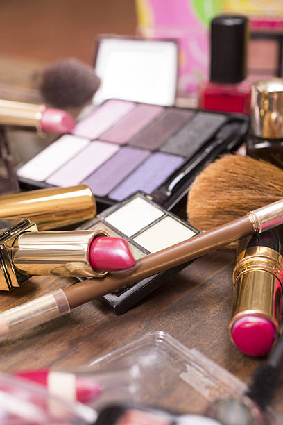 istock Pile of various cosmetics, make-up lie on wooden dressing table. 638691298