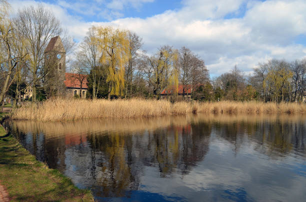 istock Village pond with rural church 638691304