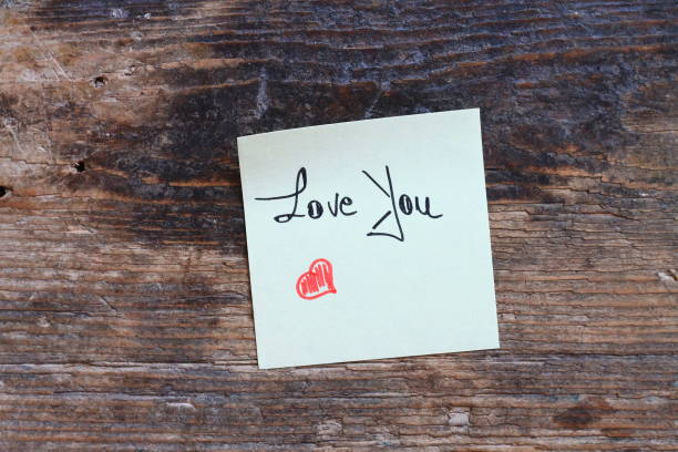 istock Message Love You with small red heart on wooden table 638692228