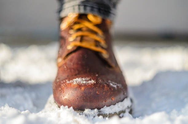 istock Snow melts on brown winter boots. 638693148