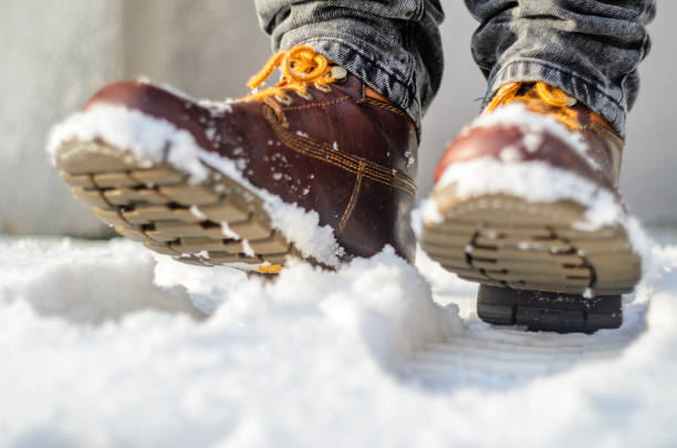 istock Brown leather shoes in the snow. 638693716