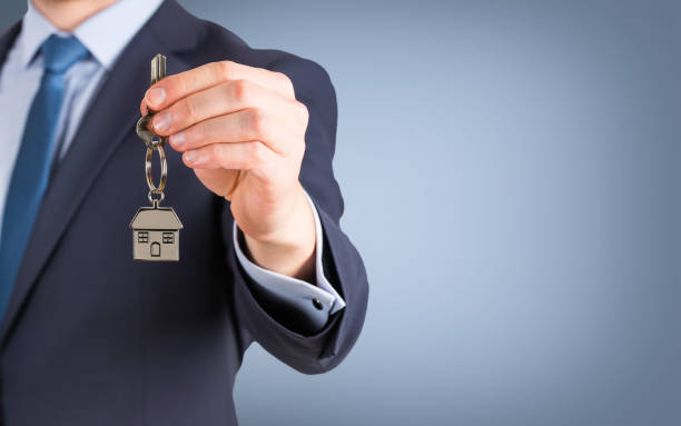istock Estate agent giving house keys 638694762