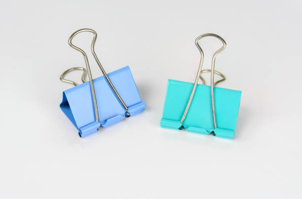 istock Blue and green paper clip isolated on white background. 638694826